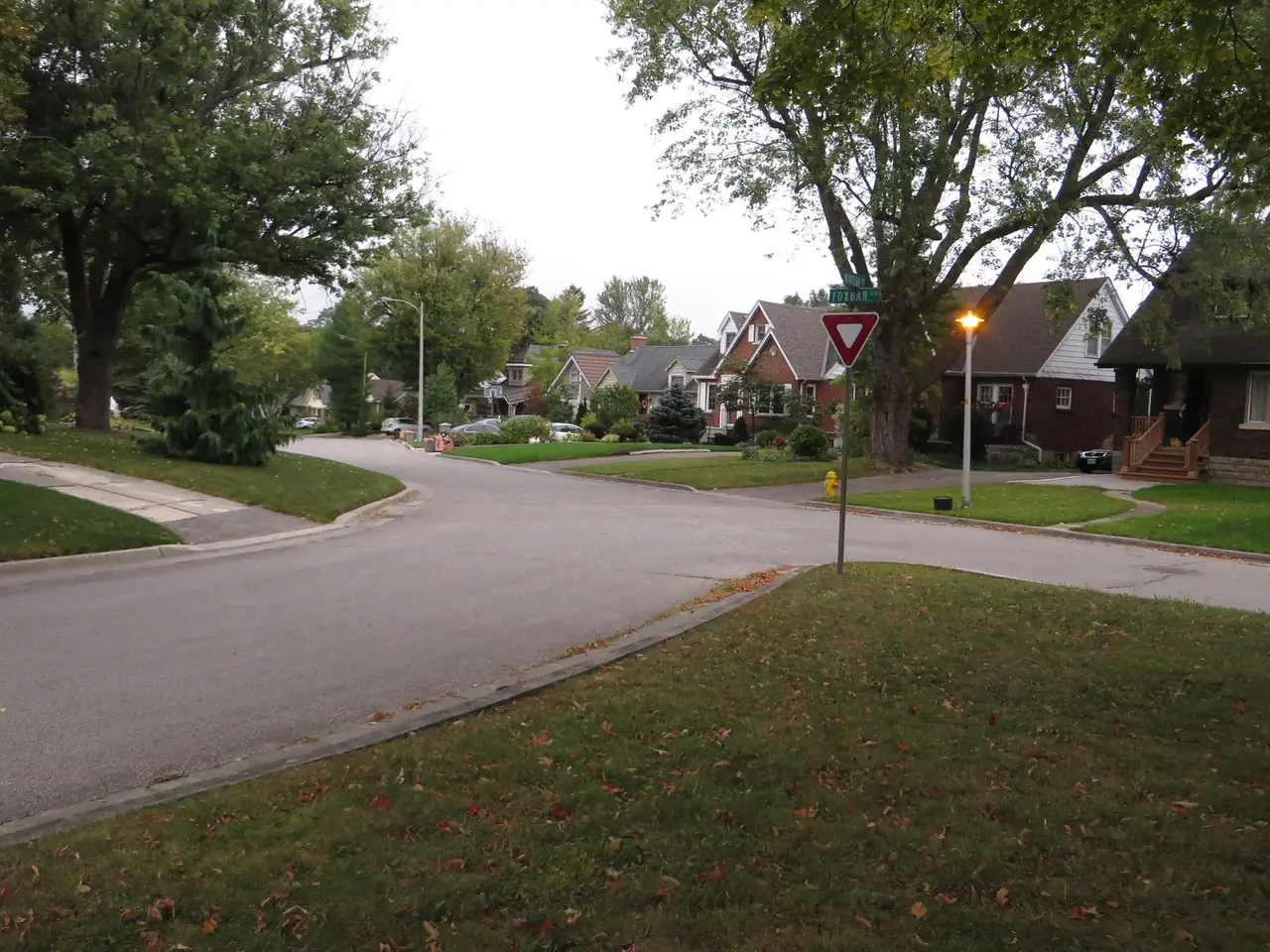 A residential intersection of brick houses and mature trees at Foxbar Road in the Old South neighbourhood of London, Ontario.